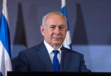 Arab Vote Fraud? Election ‘Stolen’ Claim Meets Wall man in suit at podium with microphones